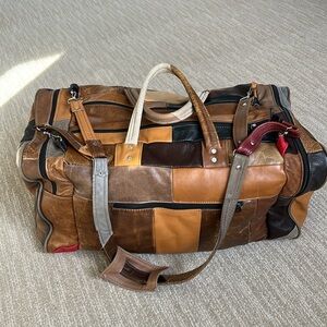 brown patched authentic leather travel bag with multiple large pockets